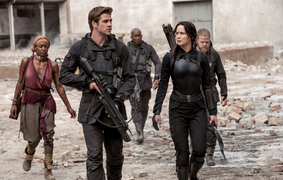 In this image released by Lionsgate, Jennifer Lawrence portrays Katniss Everdeen, right, and Liam Hemsworth portrays Gale Hawthorne in a scene from "The Hunger Games: Mockingjay Part 1." (AP Photo/Lionsgate, Murray Close)